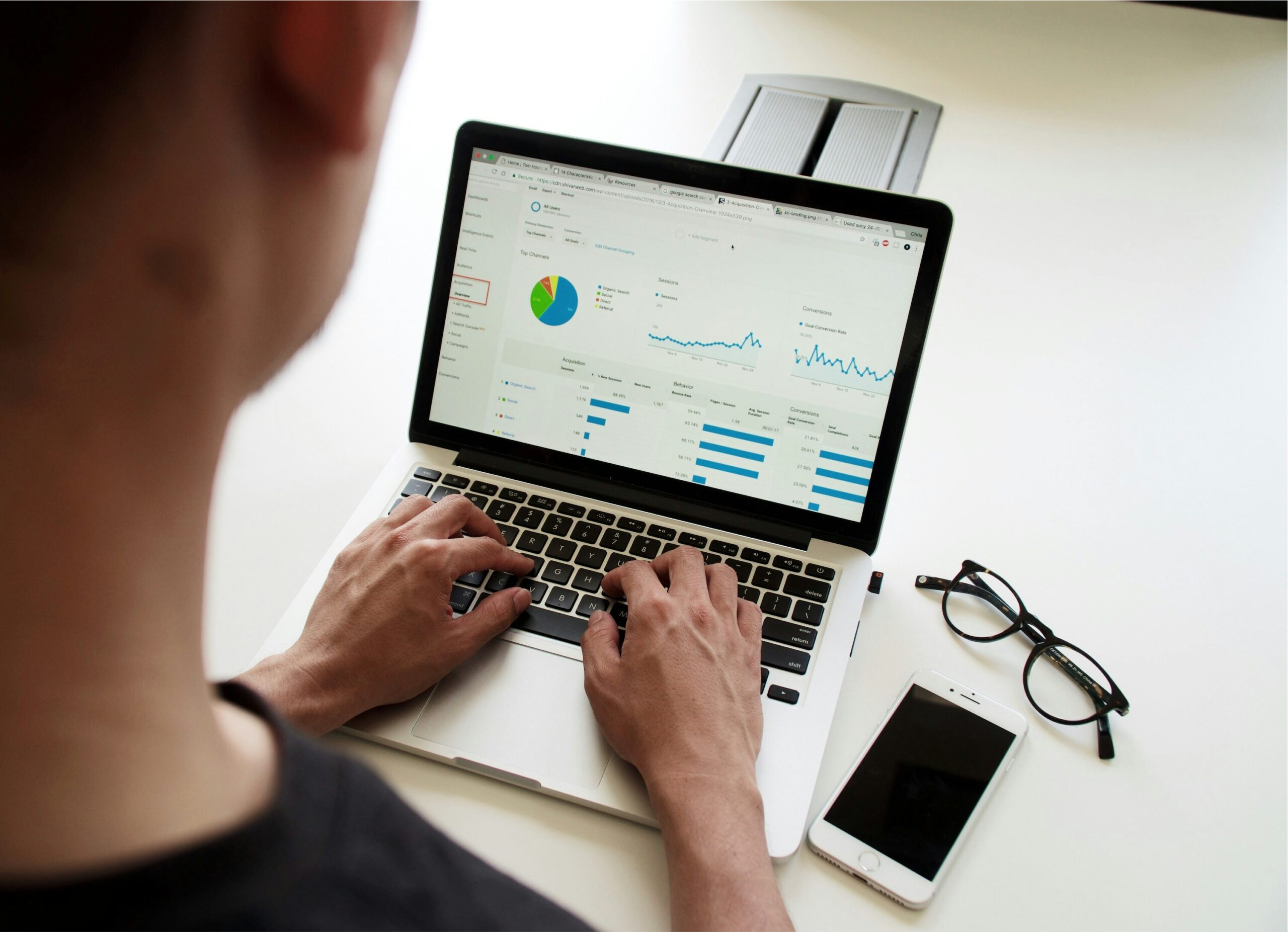 Person viewing an analytics dashboard on a laptop screen, monitoring marketing strategy progress and evaluating ad effectiveness.