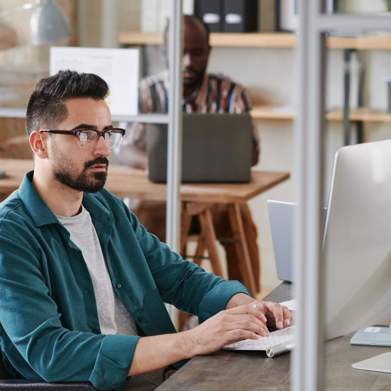 Professional man wearing glasses reviewing reports showcasing Live Well Insights, including emotional drivers and segmentation analysis.