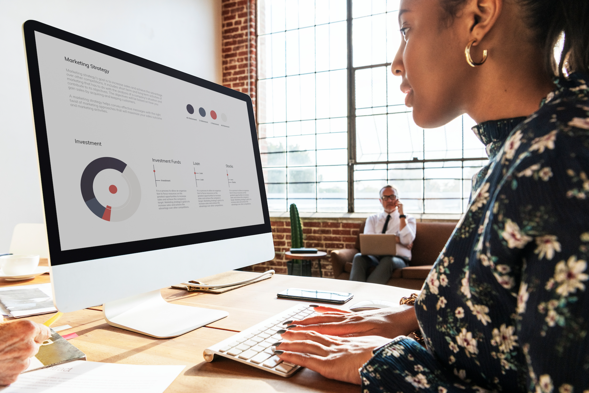 Woman reviewing B2B market research reports, deeply focused on analyzing data and insights for strategic business planning.