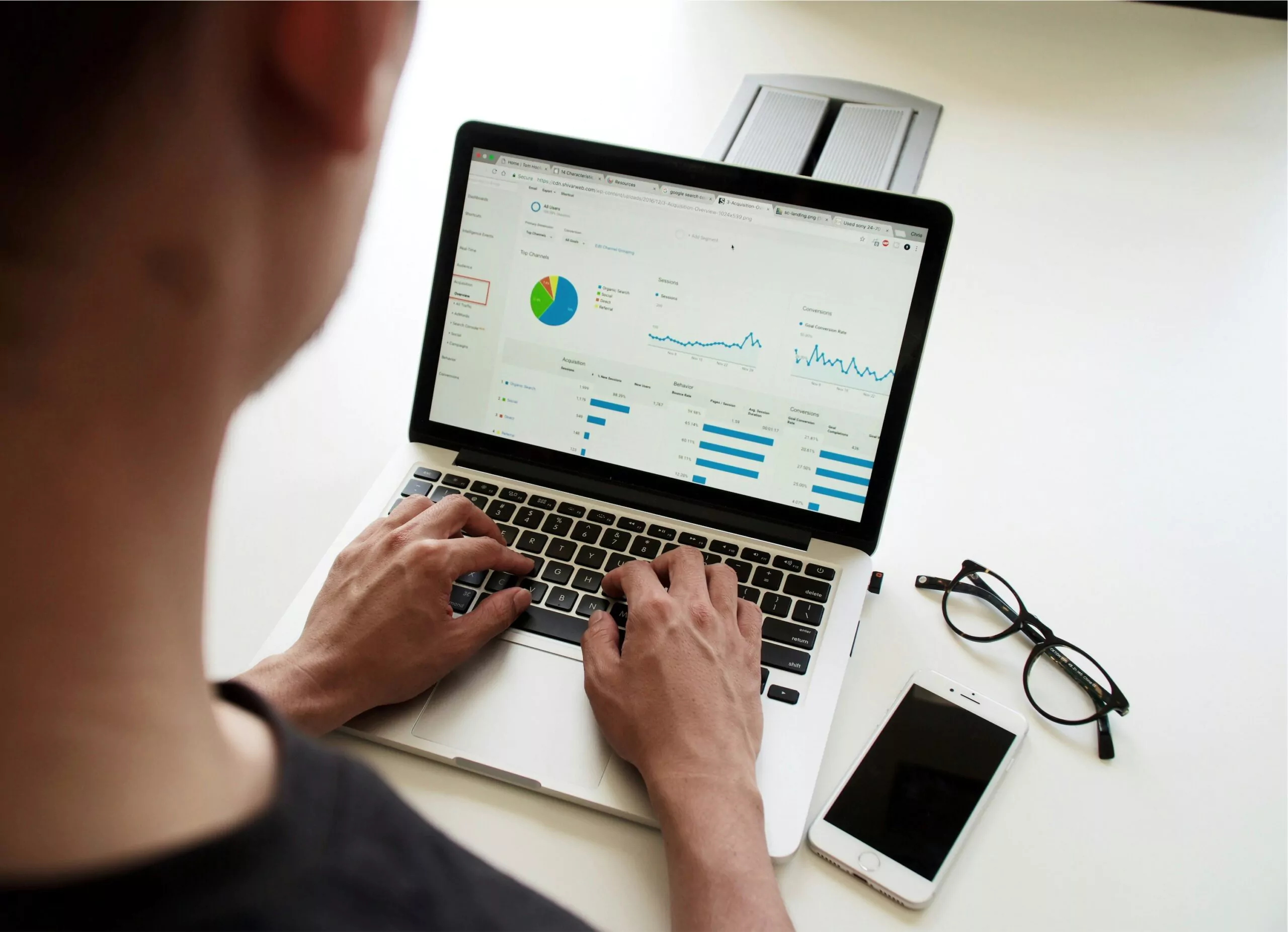 Person viewing an analytics dashboard on a laptop screen, monitoring marketing strategy progress and evaluating ad effectiveness.